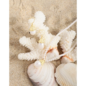 S925 silver bellflower pearl necklace and earrings set on shells with a beach background