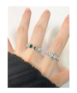 Detail of S925 silver irregular lava ring with iridescent moonstone and green gem