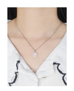 Detailed close-up of a S925 silver heart necklace with pink zircon and white enamel pendant
