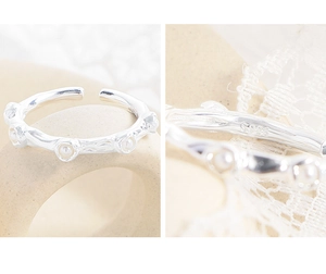 Detailed view of S925 sterling silver stamp on the inner band of a textured pearl ring