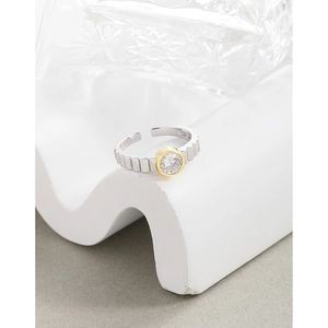 S925 sterling silver gear ring with round zircon inlay on a white minimalist pedestal