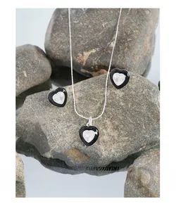 Detail of S925 silver heart necklace and earrings set with black enamel and zircon