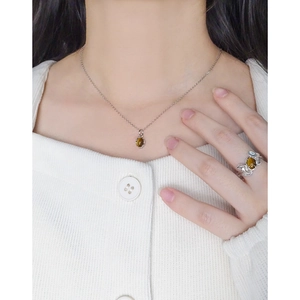 Minimalist S925 silver necklace and ring set with oval tiger eye stones worn by a model