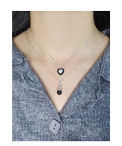 Close-up of S925 silver layered necklace with black heart pendant and zircon detail