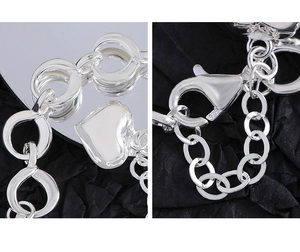 Detail of S925 sterling silver lobster clasp with 925 hallmark on heart charm bracelet