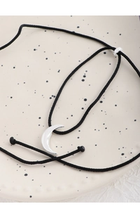 Detail of S925 silver crescent moon pendant on adjustable black cord necklace