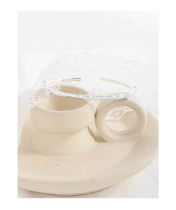 Detail of silver S925 bracelet with irregular texture and pearl-like accents