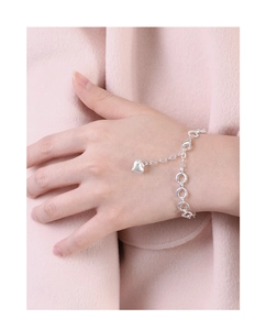 Silver lobster clasp and heart pendant detail on an elegant link bracelet for women