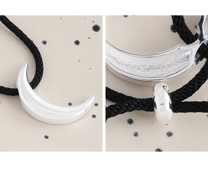Macro detail of S925 sterling silver crescent pendant with black rope and hallmark