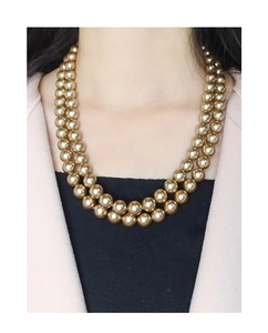 Detail of double-layer champagne gold pearl necklace worn as a choker by a model