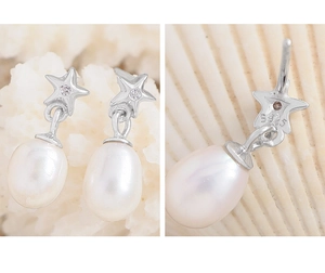 Macro detail of S925 sterling silver hallmark and natural pearl star drop earrings