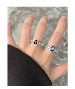Detail shot of vintage S925 silver rings with black stones worn on fingers