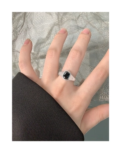 Detail view of a minimalist S925 silver ring featuring a square black zircon stone