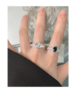 Close-up of S925 silver rings with square zircon stones worn on hand with chic texture