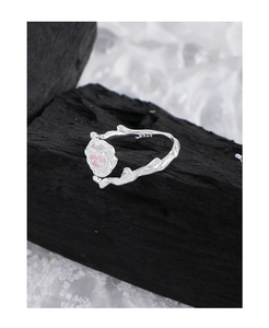 Macro shot of S925 sterling silver ring with textured branch design and pink gemstone