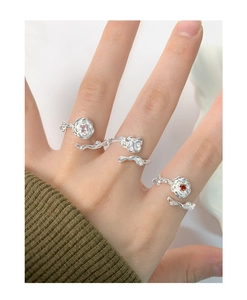 Detail of S925 silver rose rings with zircons on model hand in textured flower design