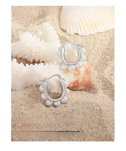 Close-up of S925 sterling silver U-shaped hoop earrings with elegant white pearls