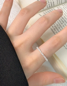 Detailed view of an S925 sterling silver ring with delicate bubble texture on a hand
