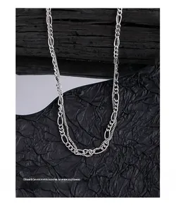 Detail view of double-layered S925 sterling silver Figaro chain necklace with a polished finish