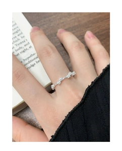 Detail of S925 silver zircon ring worn on finger with an elegant lifestyle background