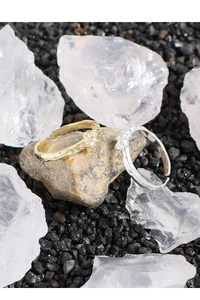 Detailed shot of gold and silver S925 textured rings with star accents on mineral stones