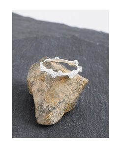 Detail of S925 sterling silver ring featuring a floral cluster of seven white zircons