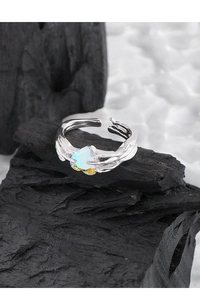 Macro detail of S925 sterling silver ring with wrinkled texture and heart zircon stone