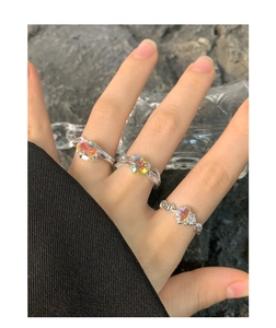 Close-up of S925 silver rings set with iridescent heart-shaped and oval zircon stones