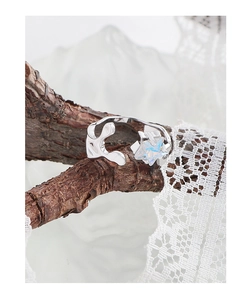 Macro detail of S925 silver irregular ring with a colorful zircon star on wood branch
