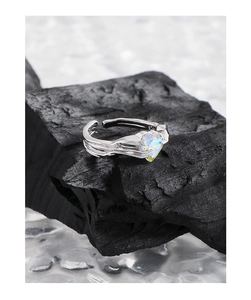 Detailed close-up of S925 sterling silver heart ring with colorful zircon on charcoal