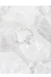 Macro view of S925 sterling silver ring with rainbow heart zircon and wavy texture