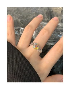 Detail view of S925 silver ring with colorful heart-shaped zircon on a model's hand