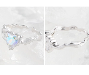 Macro detail of S925 sterling silver ring showing iridescent heart zircon and hallmark