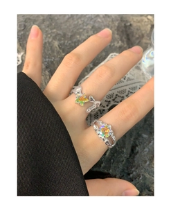 Detail of S925 silver irregular rings with colorful star-shaped zircon and fluid metal design