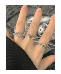 Close-up of S925 silver rings with colorful heart zircon and textured metal bands