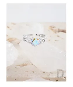 Macro shot of S925 sterling silver ring with heart shaped iridescent stone and wavy texture