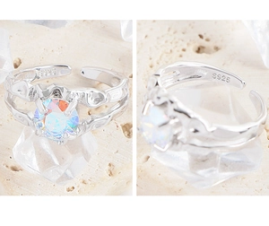 Macro view of S925 silver open ring with textured band and holographic stone inlay
