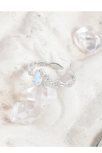 Macro detail of S925 sterling silver lava ring featuring an iridescent opal gemstone