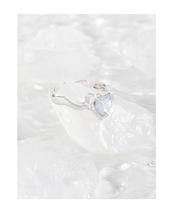 Macro detail of heart-shaped zircon and irregular liquid metal style silver ring