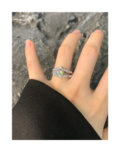 Macro detail of S925 silver ring featuring a round iridescent zircon and textured band