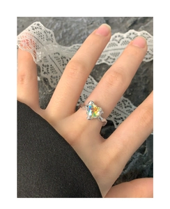 Close-up of heart-shaped iridescent crystal ring on S925 sterling silver band