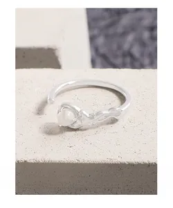 Macro shot of S925 silver ring with white agate gemstone and liquid lava texture detail