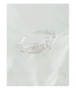 Macro shot of S925 sterling silver ring with opal and liquid metal lava texture