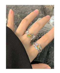 Detail of S925 silver rings with lava texture and colorful star-shaped laser stones