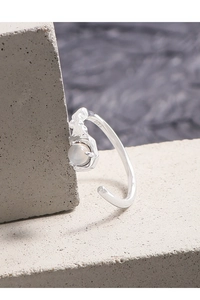 Detailed close-up of S925 silver ring with lava texture and round translucent gemstone