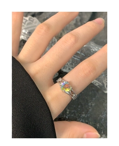Macro detail of S925 silver ring featuring a heart-shaped iridescent colorful zircon stone