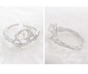 Macro detail of S925 sterling silver irregular lava ring with round white stone inlay