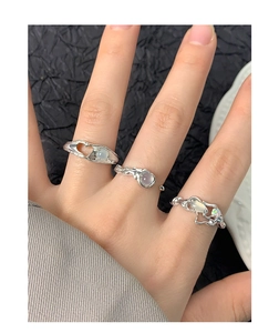 Detailed close-up of S925 silver liquid metal rings set with blue opal and heart cutout