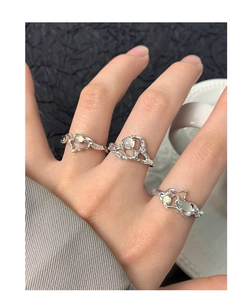 Detailed view of three irregular liquid metal S925 silver rings with opal gemstones