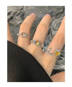 Macro detail of three stacked S925 silver rings with colorful zircon in heart and star shapes